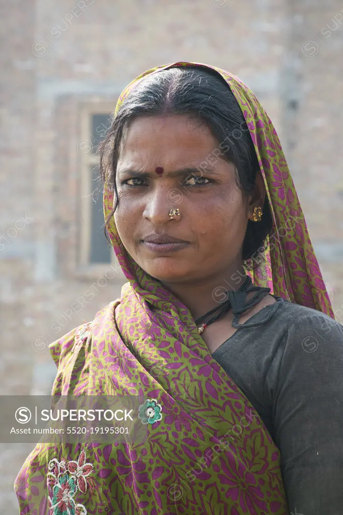 Portrait of a woman labourer working in an urban construction site