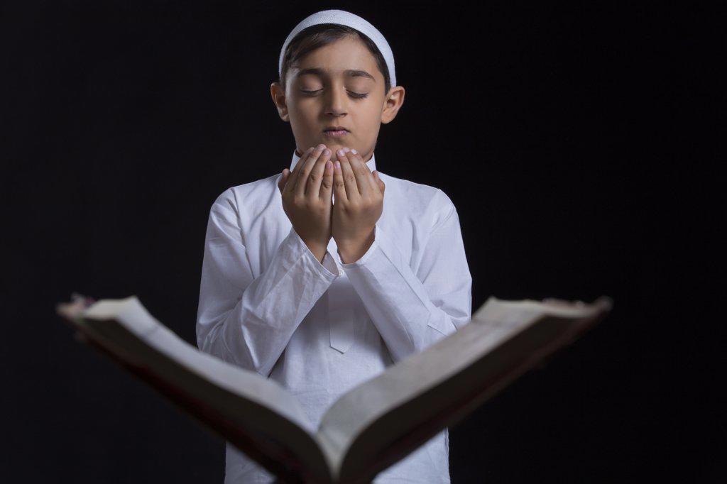 Muslim boy reading Quran