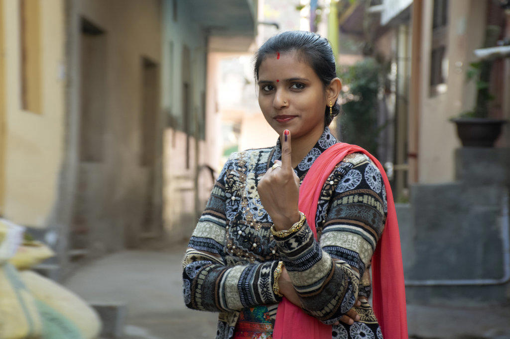 indian woman showing voting mark in hand after polling the Vote