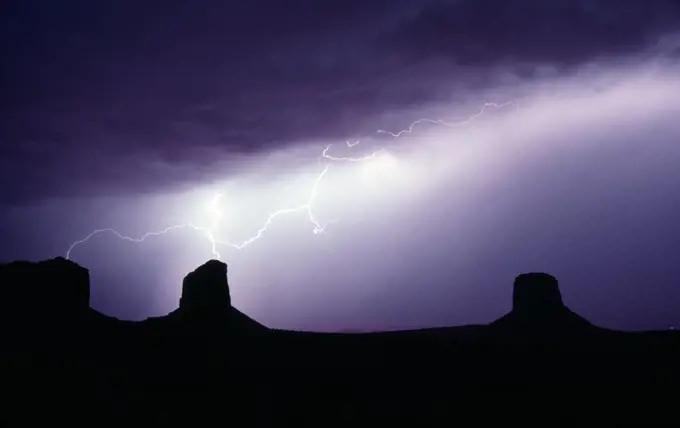 Dramatic electrical storm creates lightning bolts that hit two buttes at once