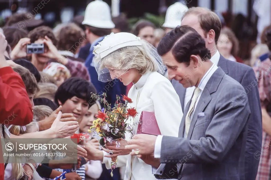 Prince Charles and Princess Diana talking to people in crowd and taking flowers on Royal Tour in New Zealand - 1983