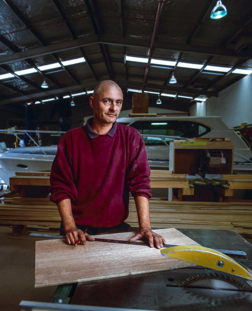 Portrait of a boat builder in his factory