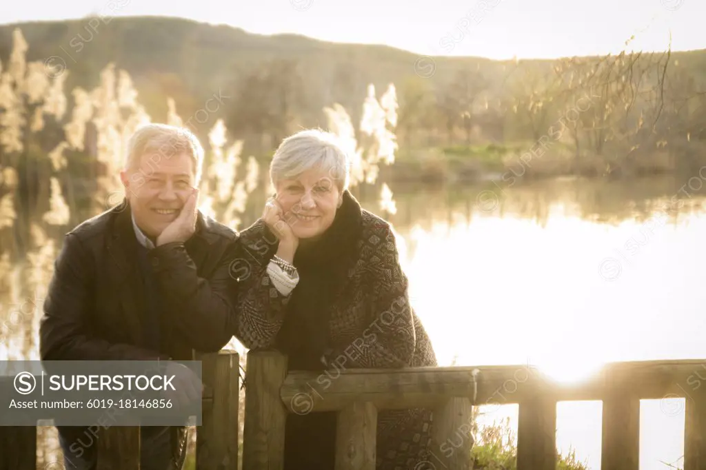 older couple models in love in the sunset