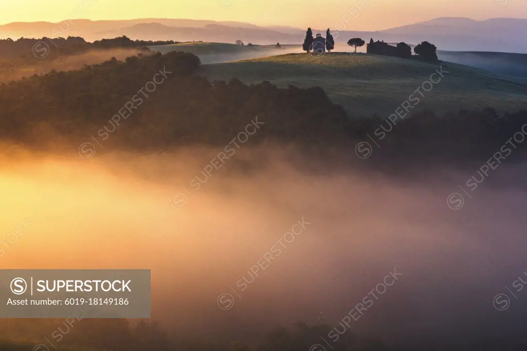 Tuscany church surrounded by cypresses