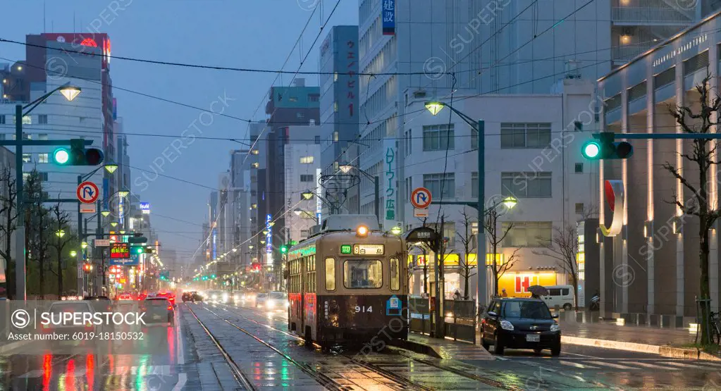 Hiroshima streets with car traffic and tram on the foreground