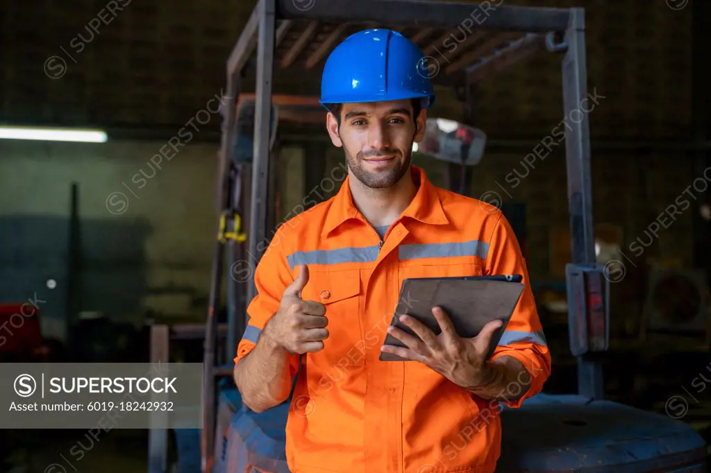 Portrait of engineer with digital tablet showing thumb up