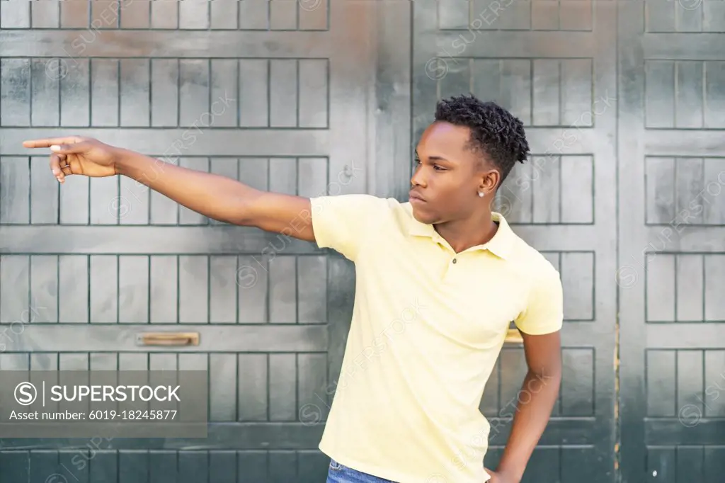 young african man pointing in a direction