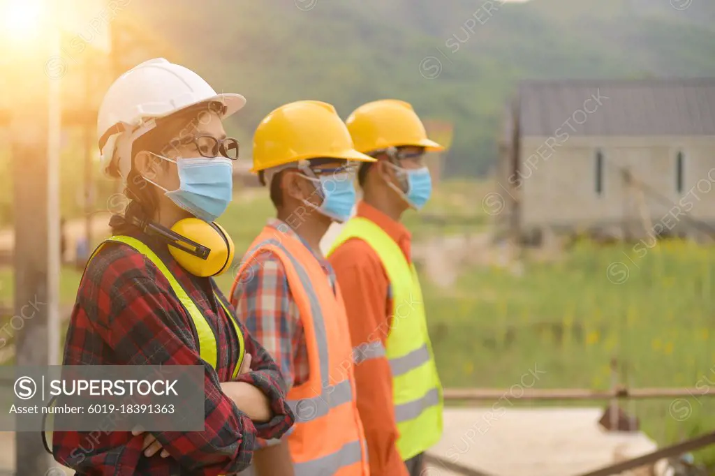 Workers wear a quarantine face mask.