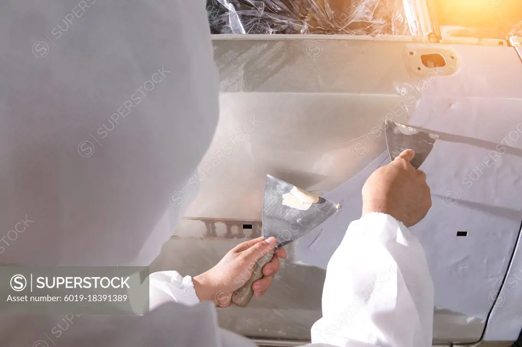 Repair and painting car mechanic.worker painting a car
