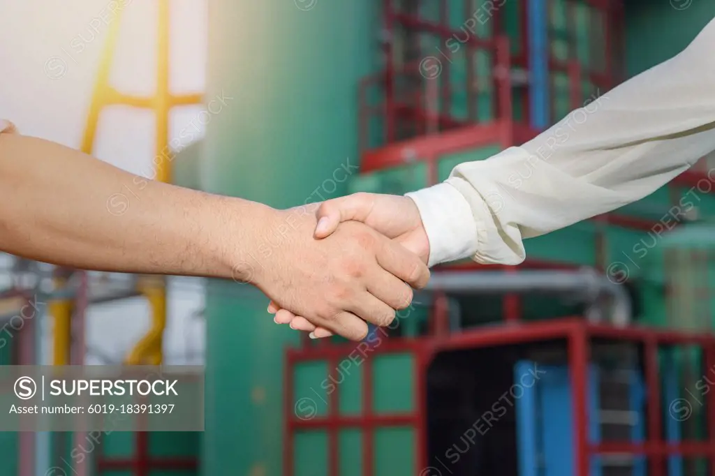 Engineer and worker team making handshake together to agree join