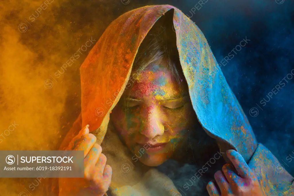 Portrait of young Indian Woman celebrating Holi color festival.