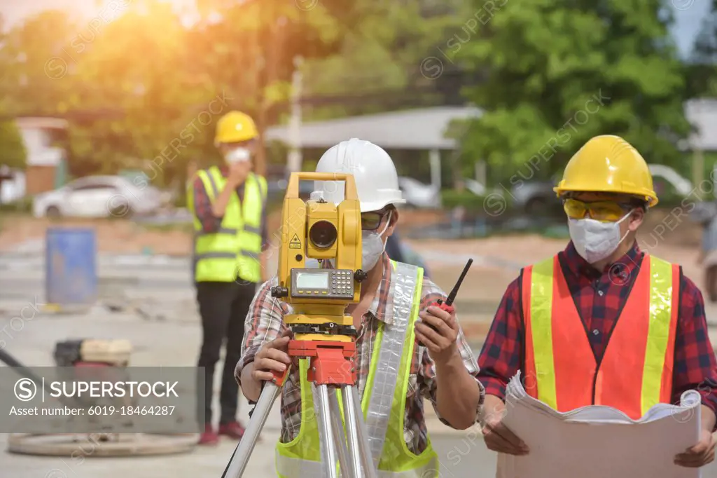 surveyor engineer worker making measuring  on road works