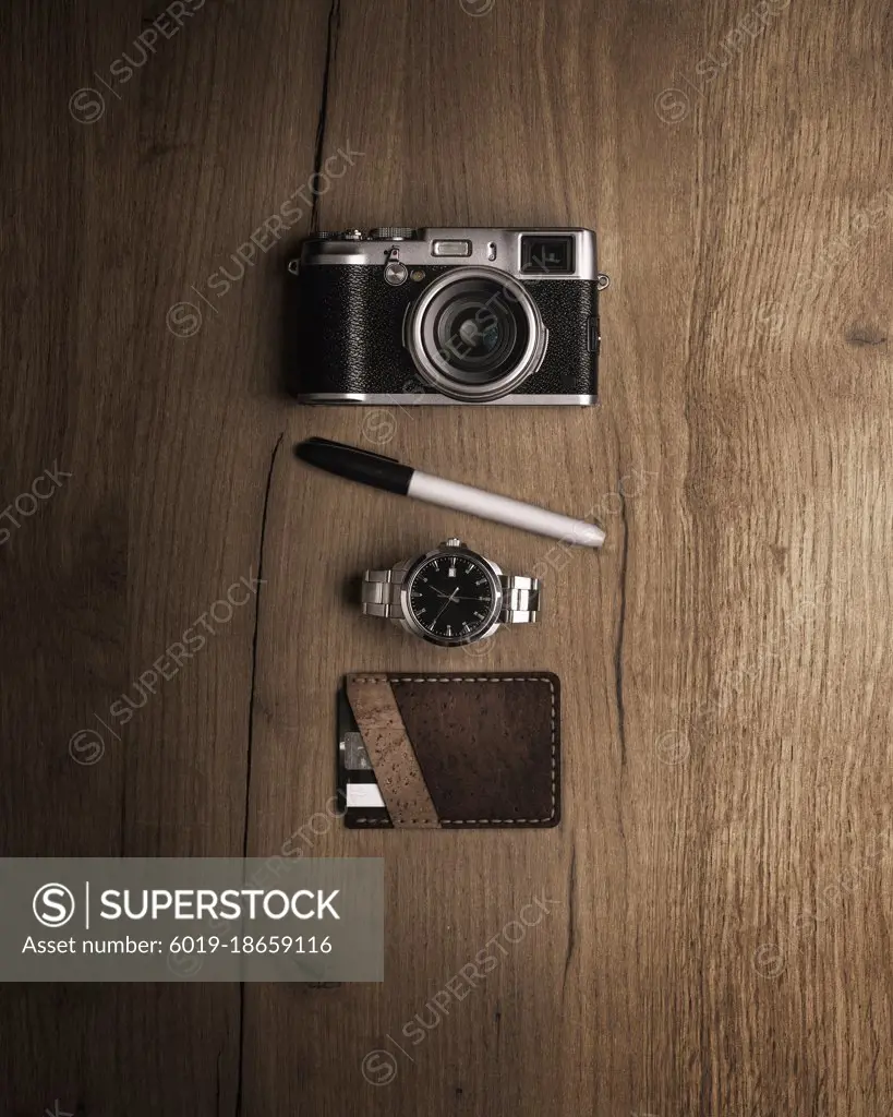 Flat layout camera, pencil, watch and wallet