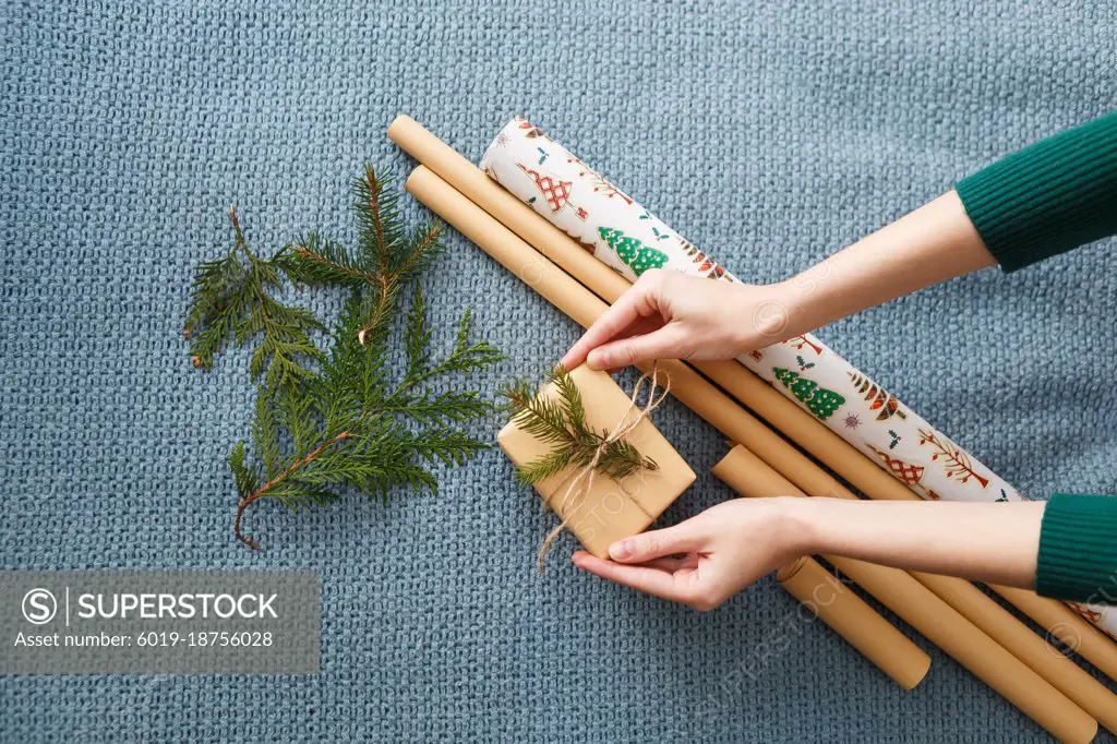 process of wrapping Christmas presents with kraft paper
