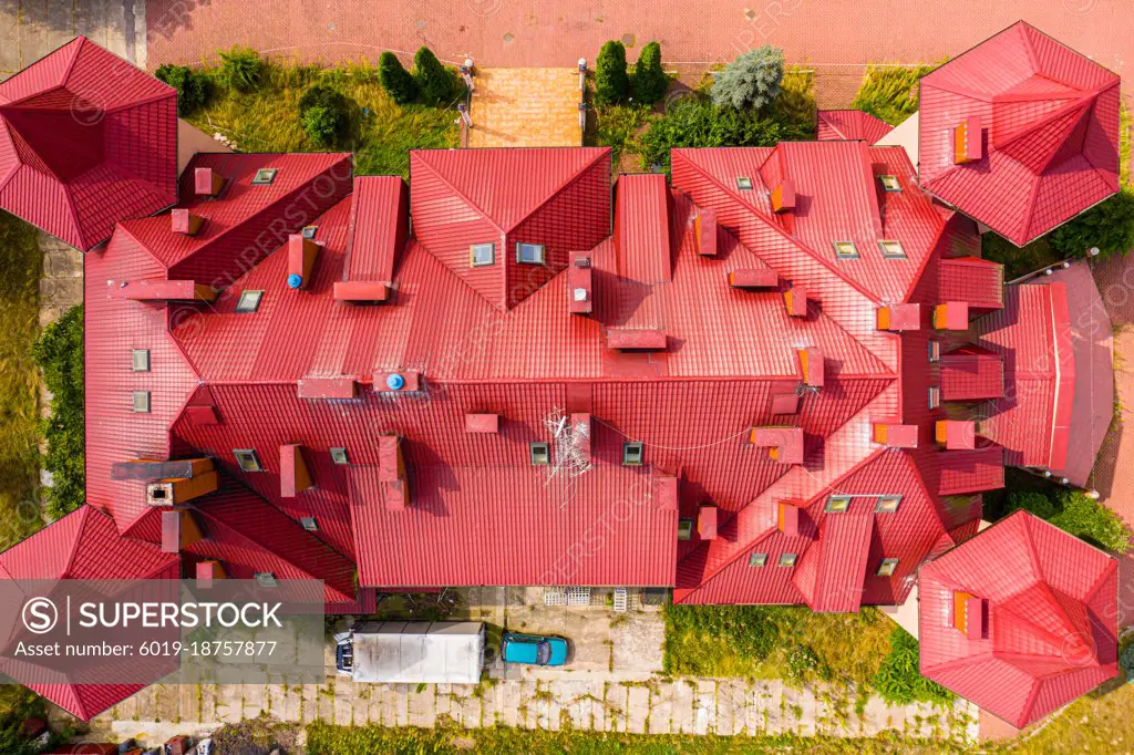 Top aerial view of building complex shingle roof construction. A