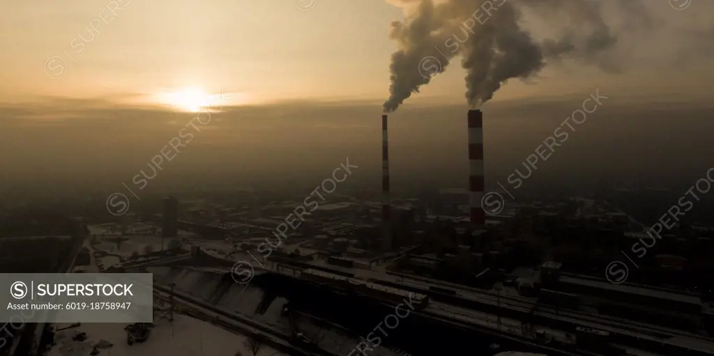 Power Plant emissions seen above the city  during sunrise. Envir