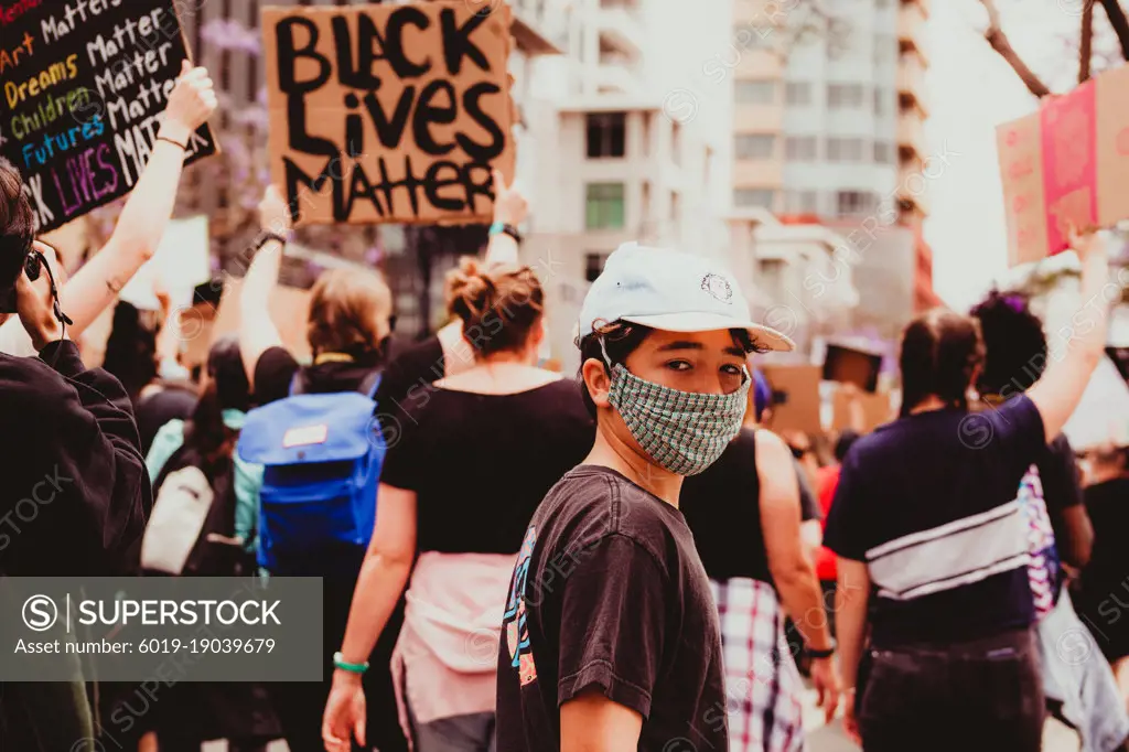 Pre-teen boy walking at a Black Lives Matter march.