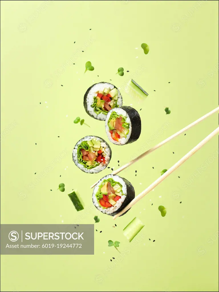 concept of flying vegan vegetables sushi and rolls levitation