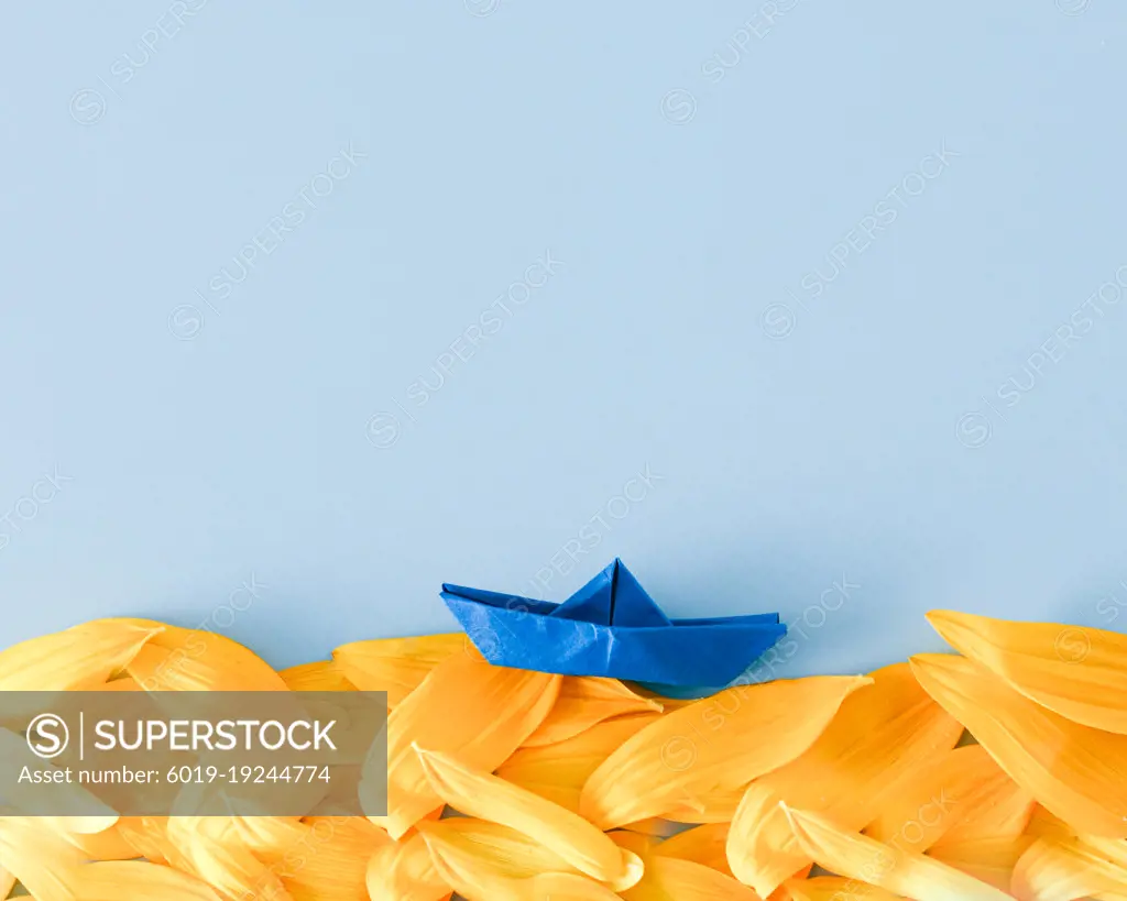 yellow-blue ukrainian colors sea with paper blue boat
