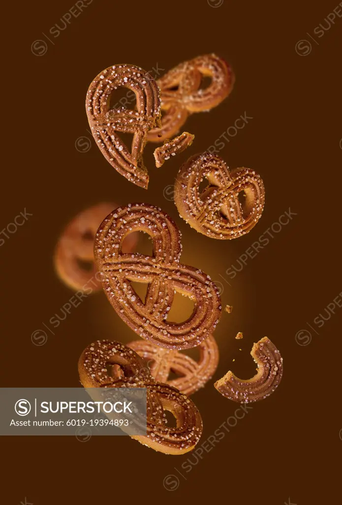 sugar cookies - pretzels swirl on coffee background, flying food