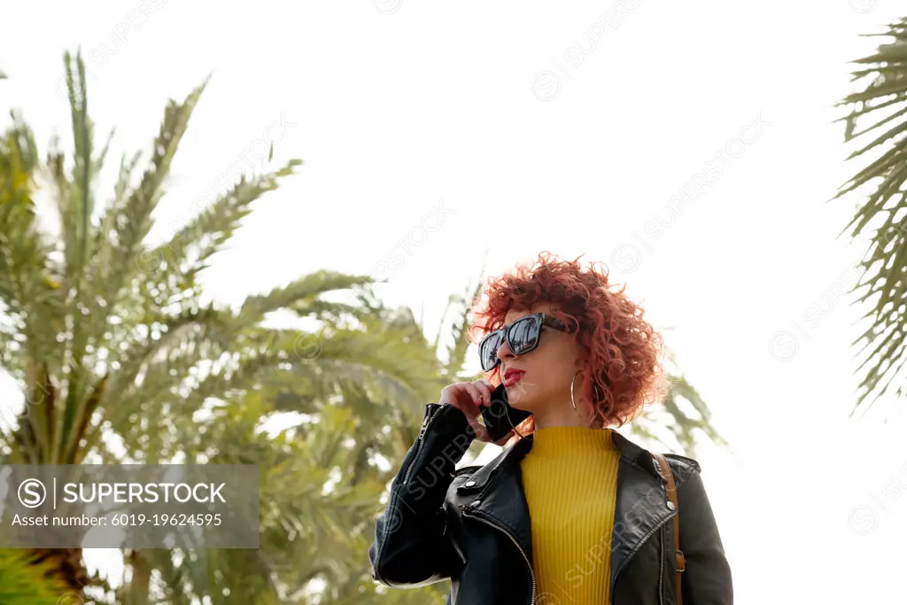 brunette talks on her mobile phone outdoors