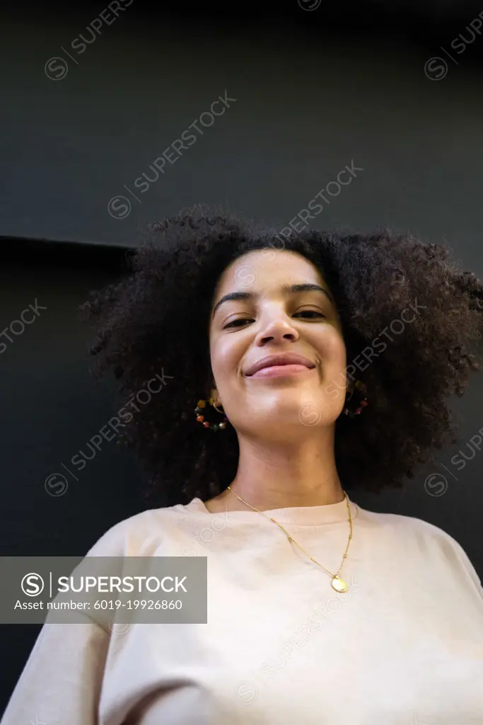 Low angle Portrait of a young woman  with curly hair