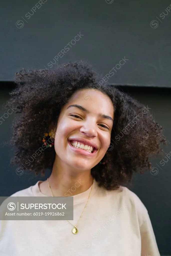 Portrait of a young woman  with curly hair smiling