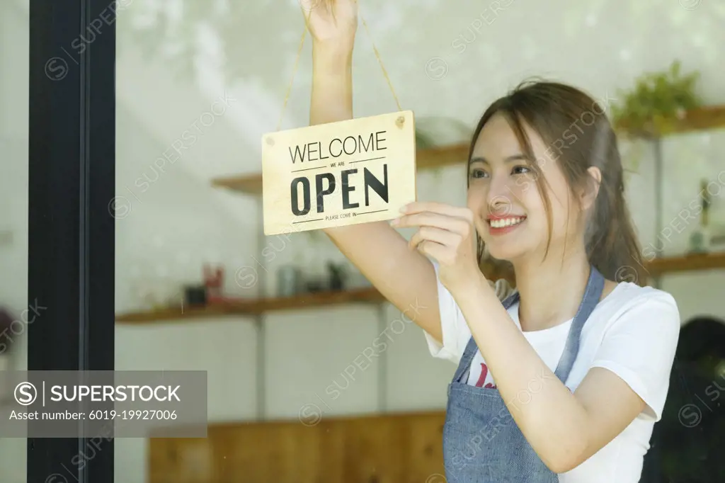 Young business owner open the coffee shop.