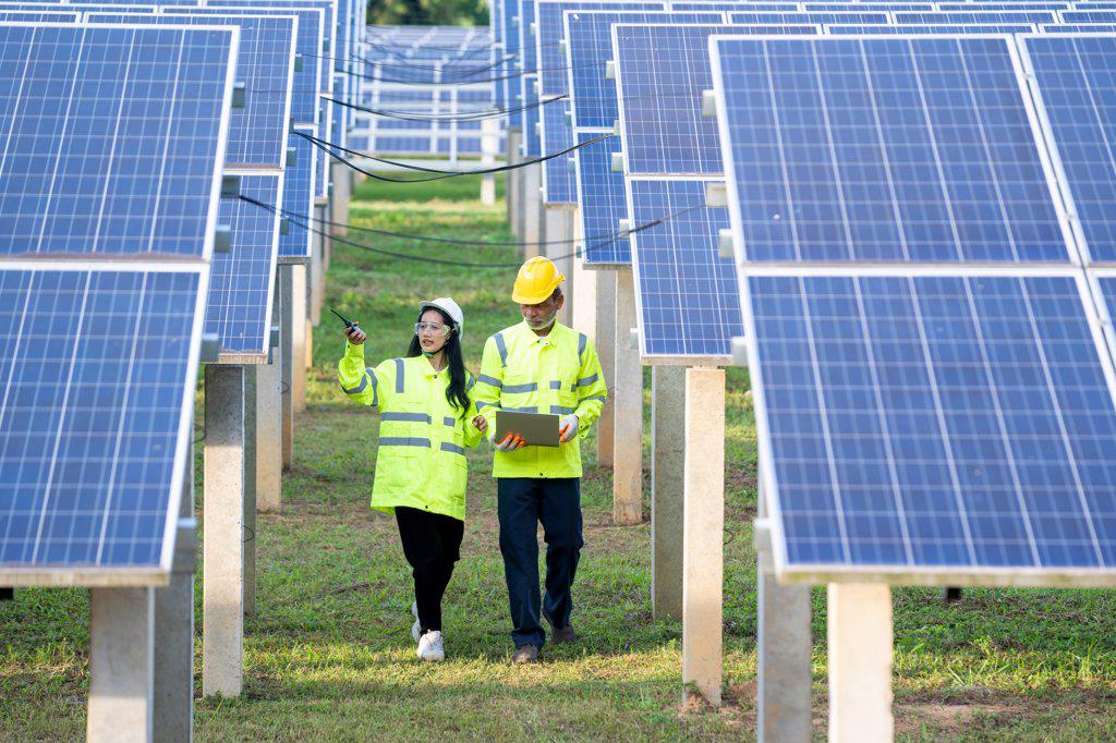 Engineer and Technician checking equipment in solar panels