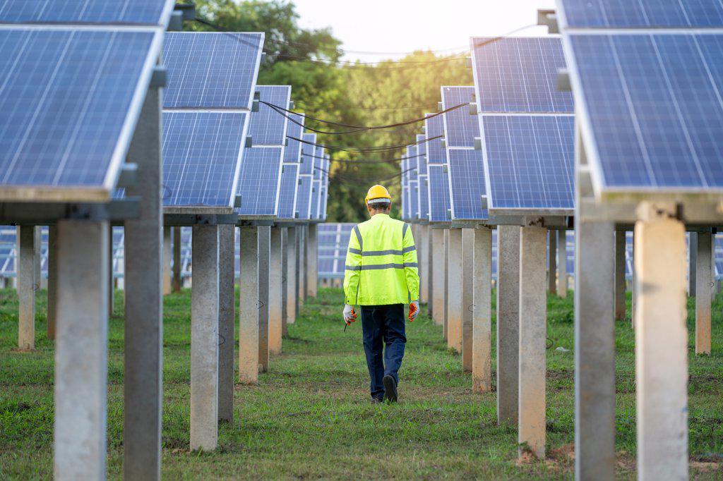 Engineer to inspect the solar panel in solar panels power farm