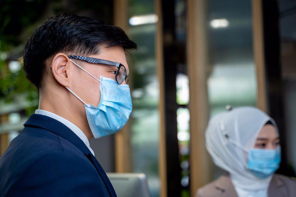 Businessman wearing protective mask to Protect Against Covid-19