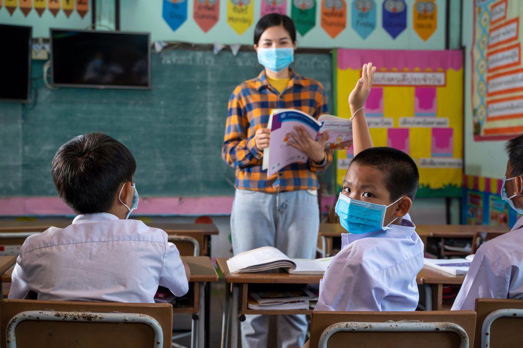 Student with face mask back at school after covid-19 quarantine