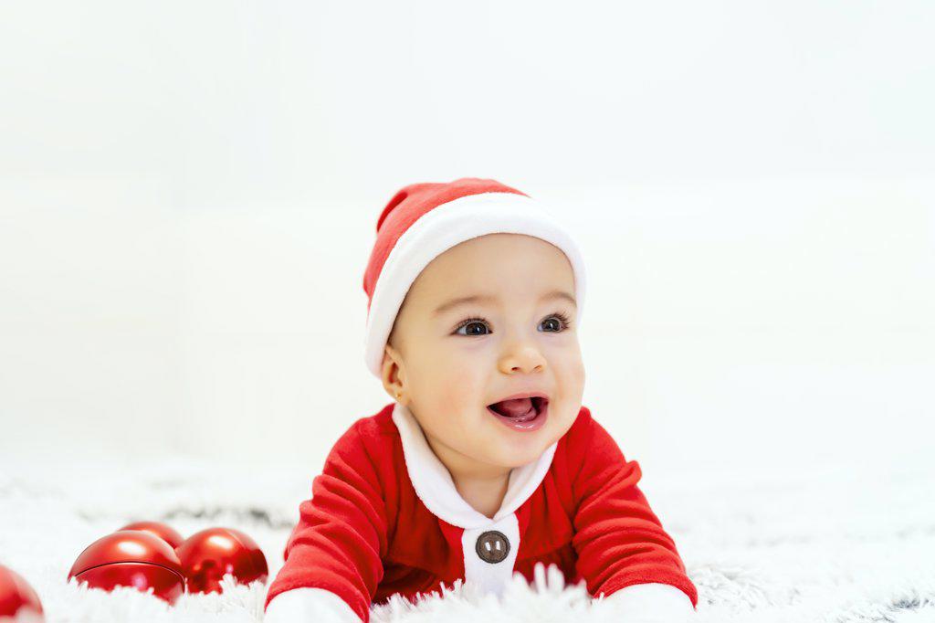 beautiful baby dressed as santa claus at christmas
