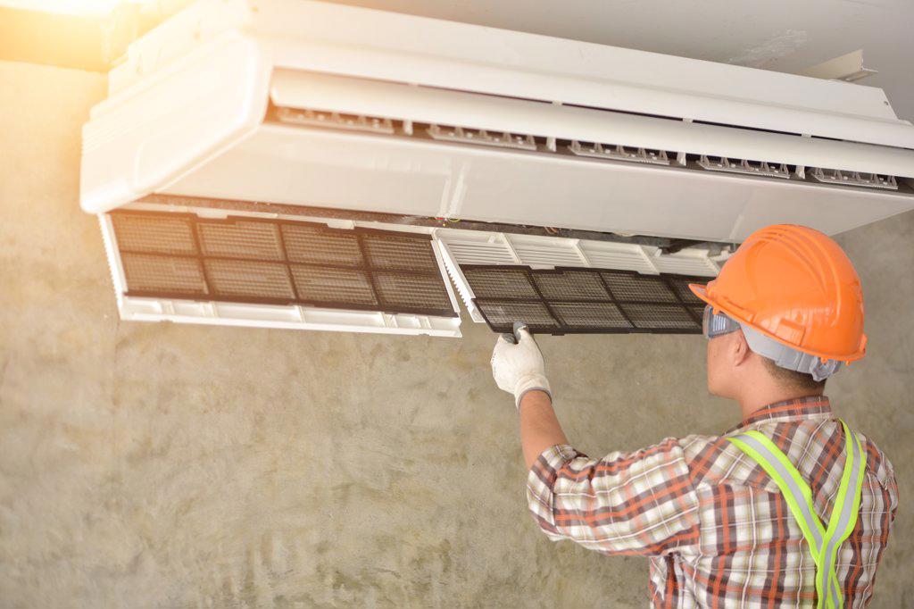 Air conditioner repairmen work on home unit