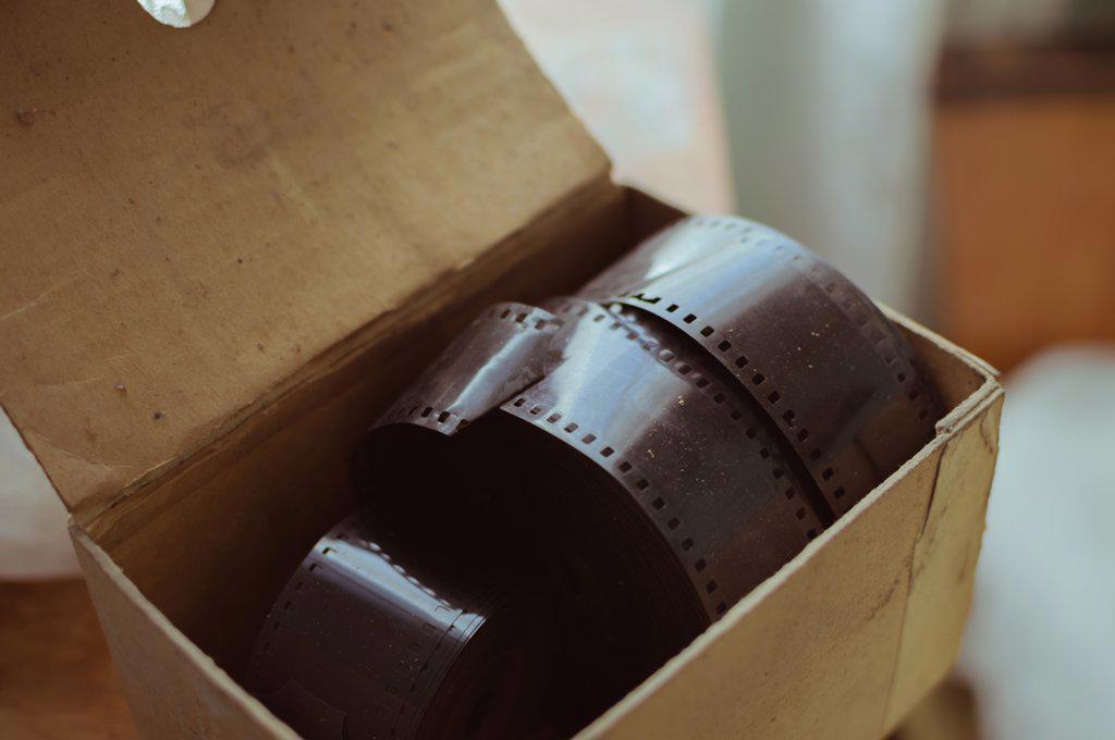 Old cardboard box with large reels of retro photo films