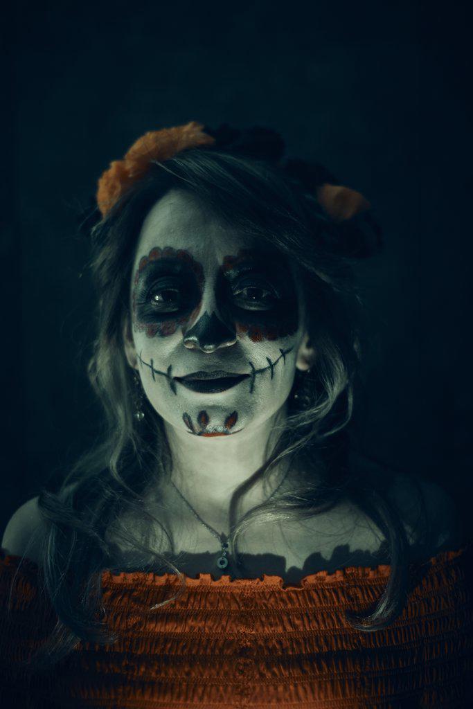 Happy woman at celebration make up of day of dead