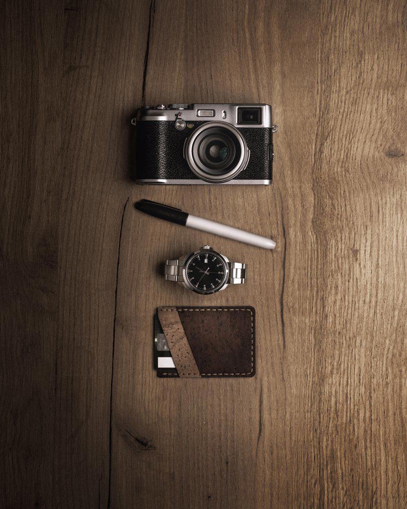 Flat layout camera, pencil, watch and wallet
