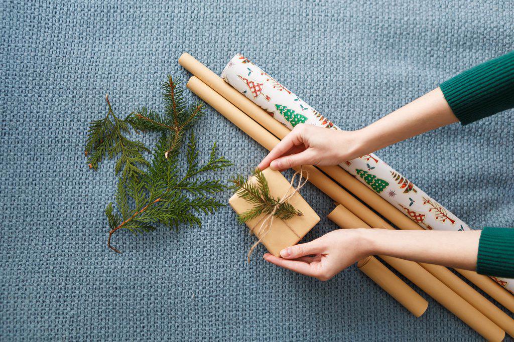 process of wrapping Christmas presents with kraft paper