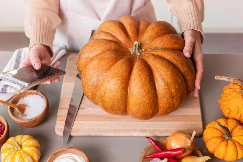 A woman is looking for a recipe for a delicious pumpkin dish.