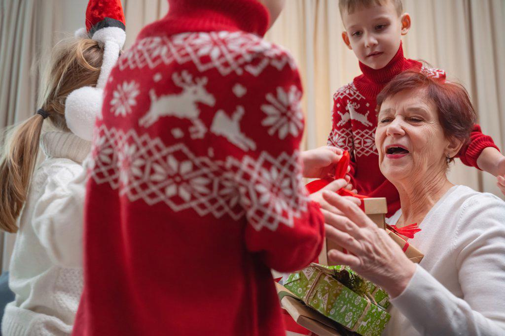 children receive gifts from grandmother