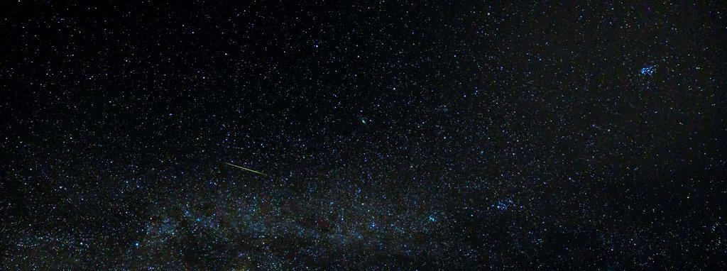A Meteor streaks across the sky near the Milky Way