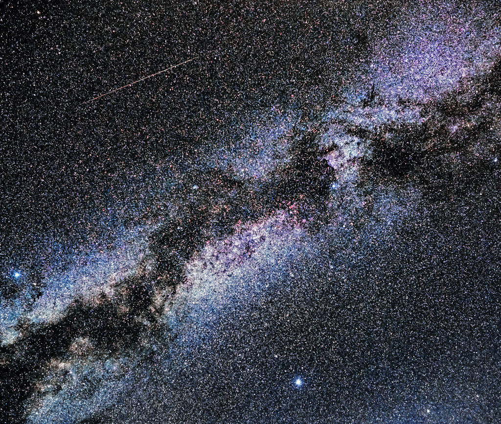 A meteor streaks across the Milky Way