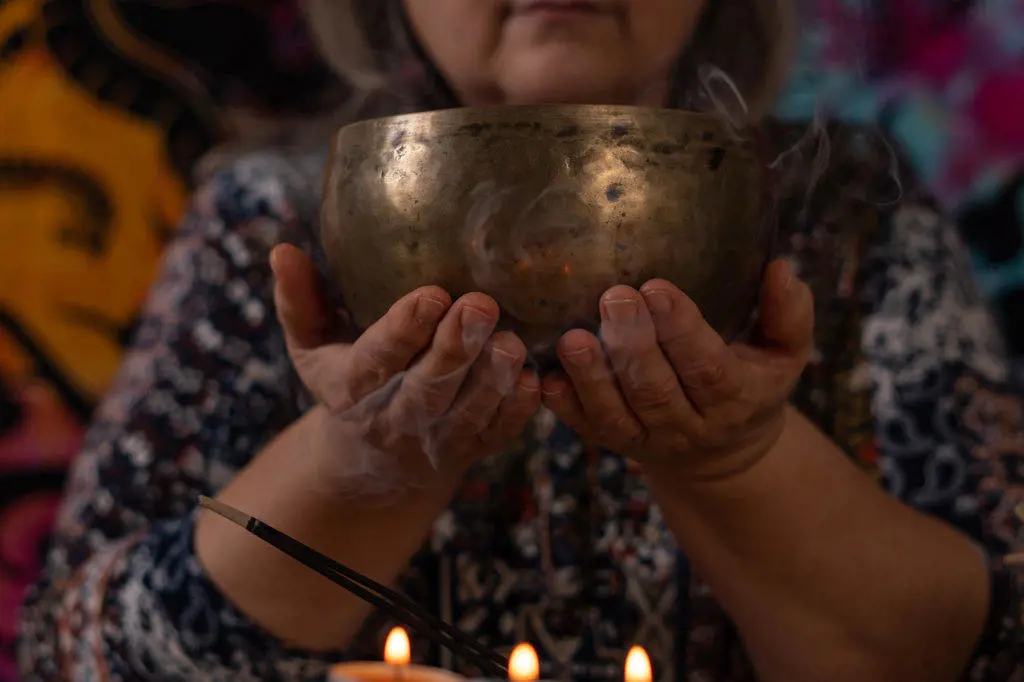 close-up of Tibetan singing bowl held by woman's hands