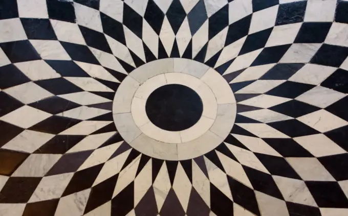 pattern is black and white diamonds on the floor. marble tiles.