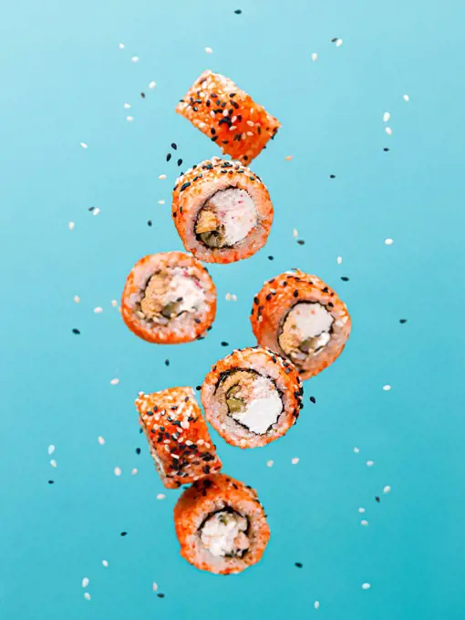 concept of flying sushi and rolls with salmon levitation