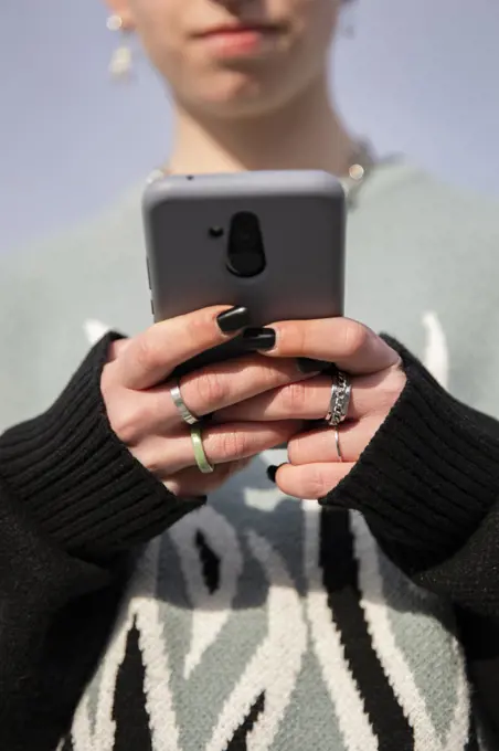 Close-up of a girl texting on her smartphone