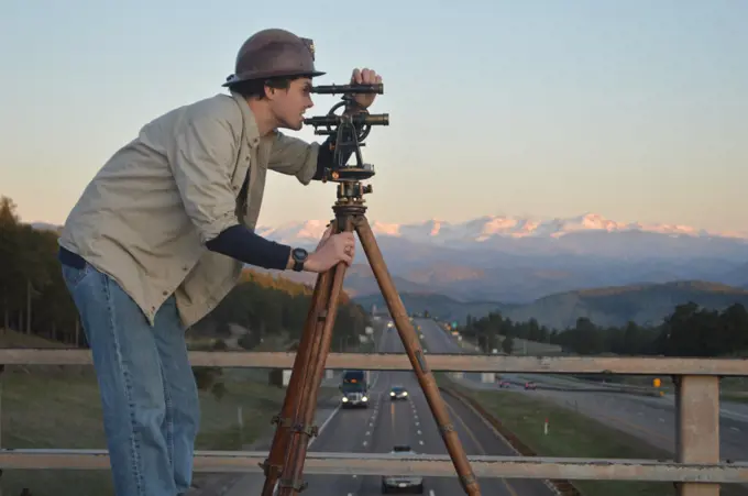 Engineer surveying highway construction, I 70, Colorado