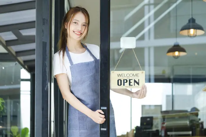 Young business owner open the coffee shop.