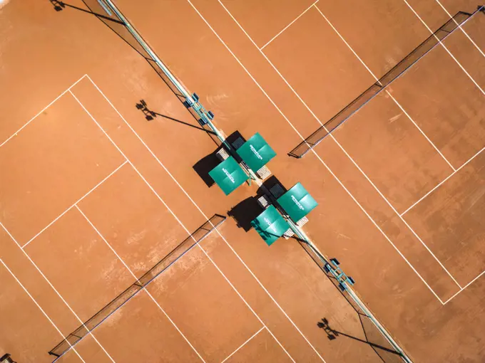 Beautiful top down view to orange tennis clay court with white lines