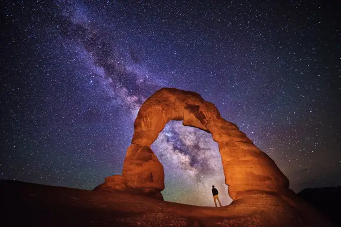Portrait under delicate arch with the milky way, Arches National Park